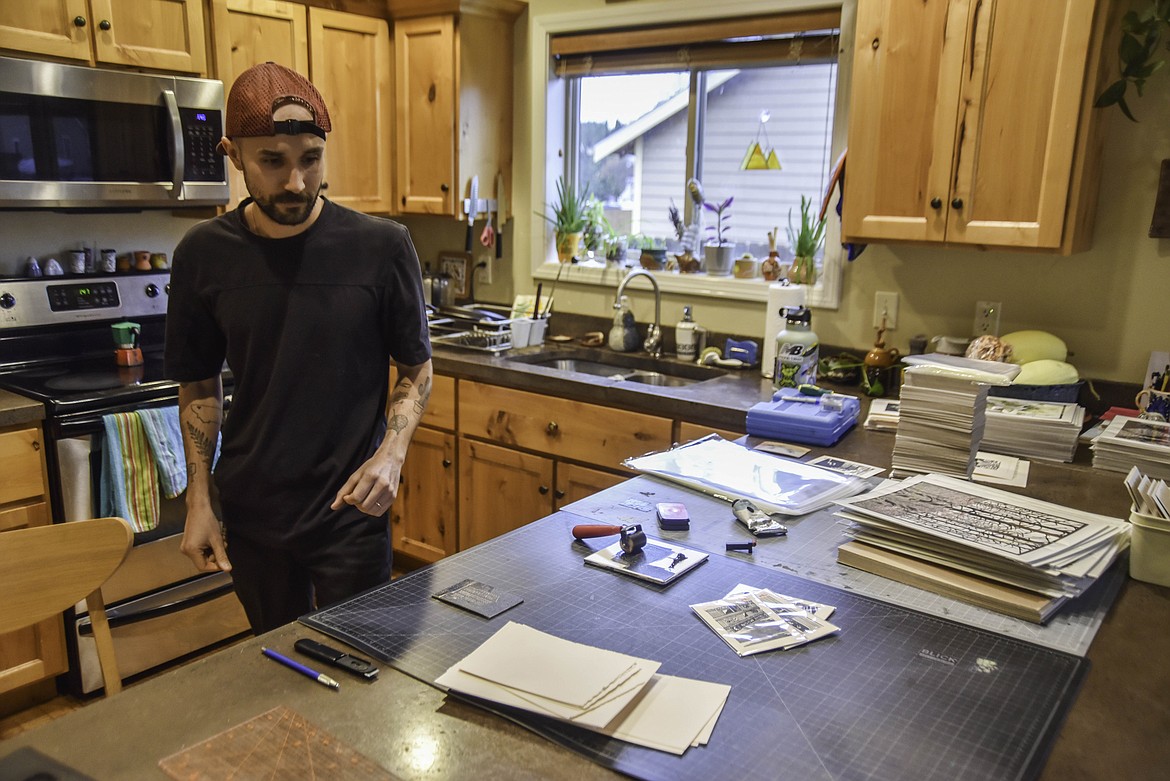 Tarek Penser, of Tarek's Prints, prepares to transfer a print of Blackstar Bar in Whitefish. (Kate Heston/Daily Inter Lake)