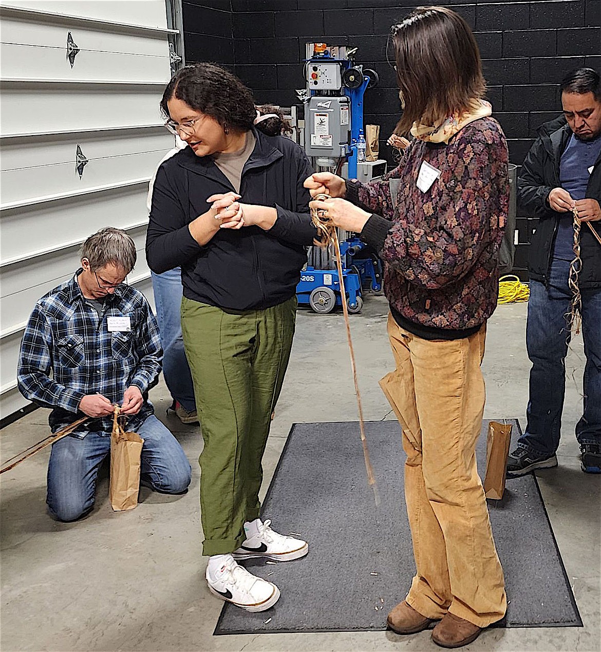 Attendees at the Regional Climate Change Conference held at SKC Nov. 21-22 learn to make cordage from dogbane stalks. (Berl Tiskus/Leader)