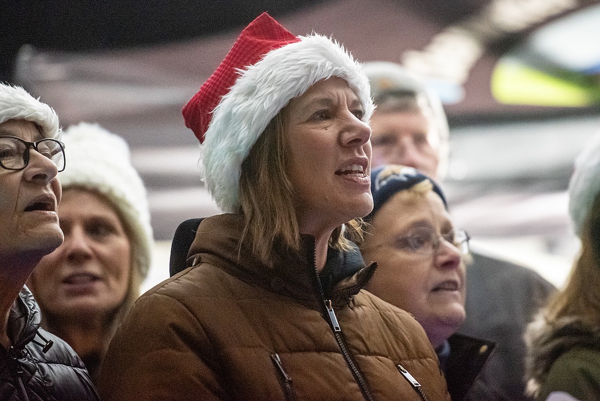 Community United Methodist Church pastor Wendy Ochs sings with the choir at Bigfork's Christmas tree lighting Saturday, Nov. 23. (Avery Howe/Bigfork Eagle)