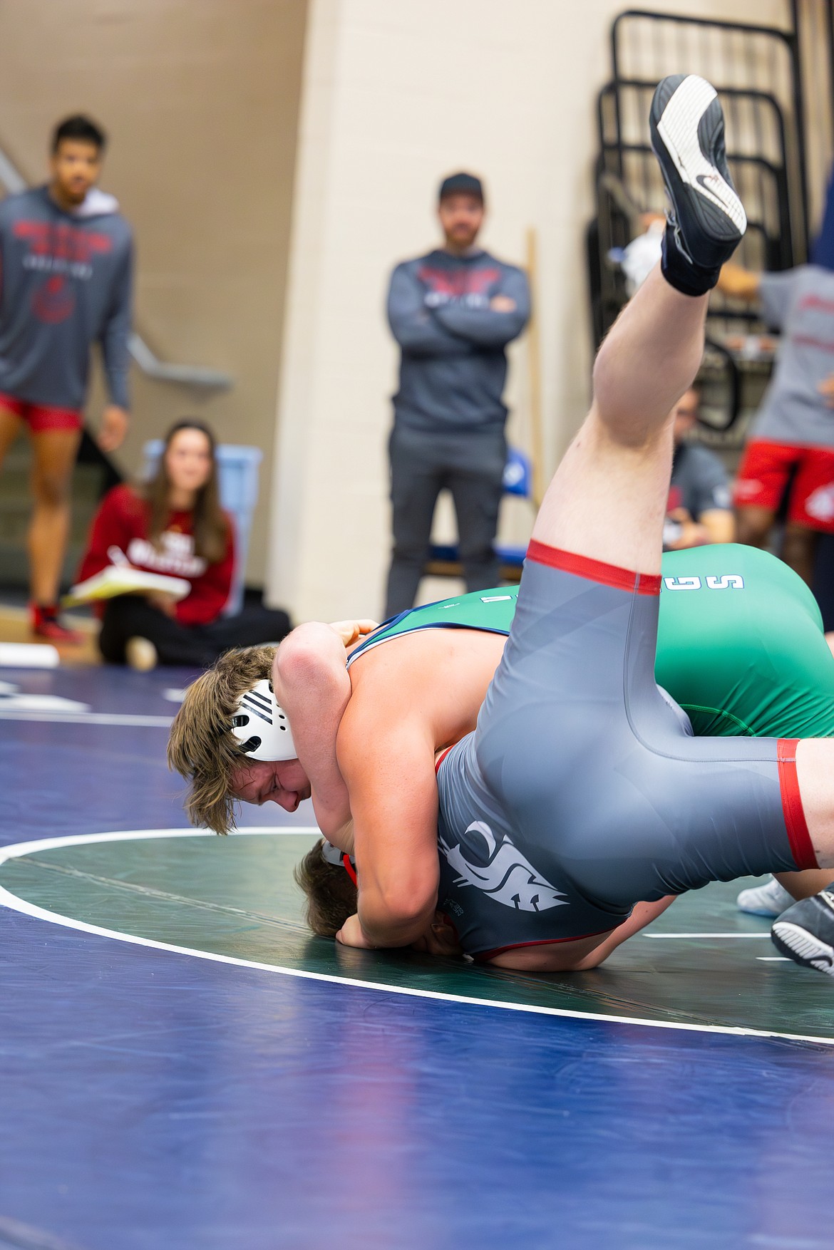 Big Bend Community College sophomore Mac Laird of Ephrata hurls a WSU Cougar wrestler into the mat.