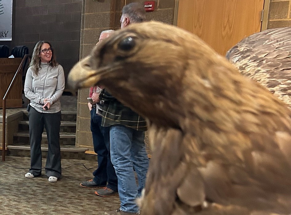 Carrie Hugo chats with guests following her talk about bald eagles at the Coeur d'Alene Public Library Meeting Room on Monday.