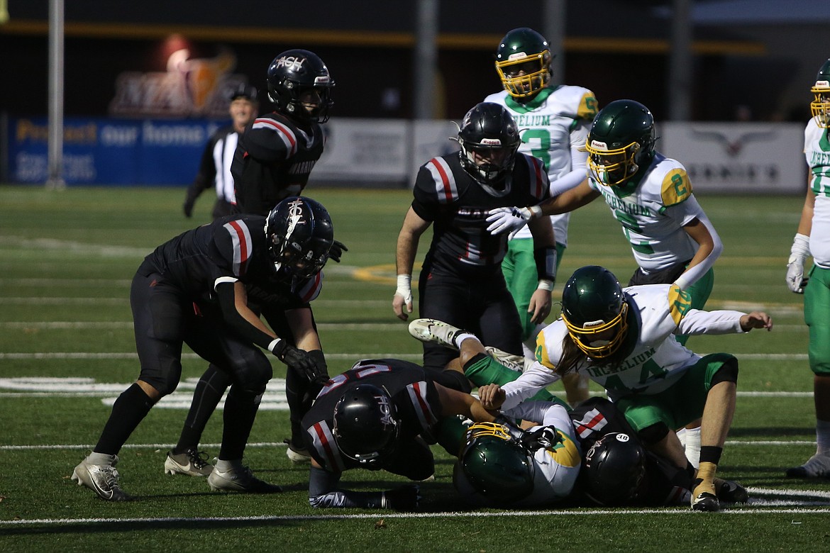 Almira/Coulee-Hartline defenders rally to tackle an Inchelium player during a state playoff game on Nov. 15. The Warriors held Neah Bay, who came into the game averaging 58.6 points per game, to 12 points on Saturday.