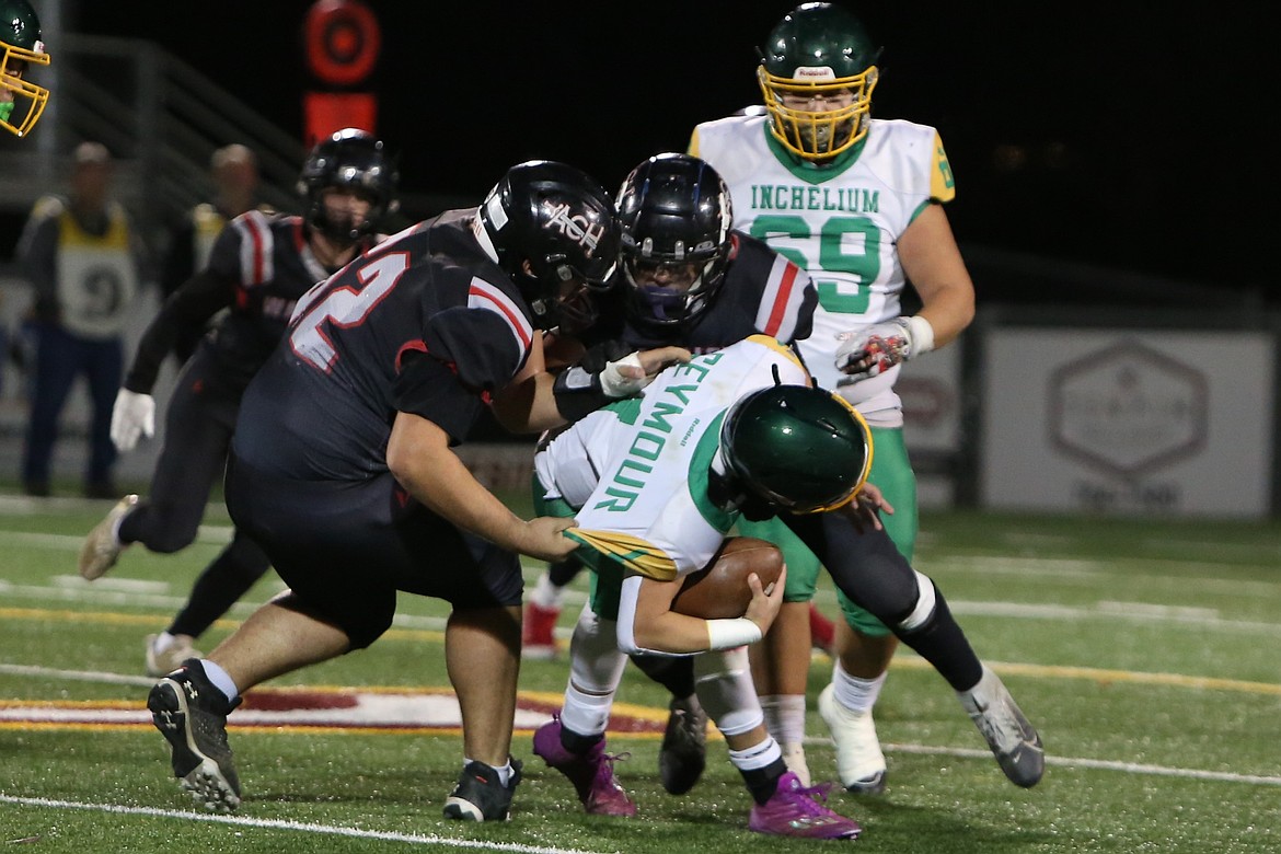 Almira/Coulee-Hartline defenders tackle an Inchelium player for a loss during a Nov. 15 game. The Warriors had four sacks Saturday against Neah Bay, including one by senior Grayson Beal, right, in black.