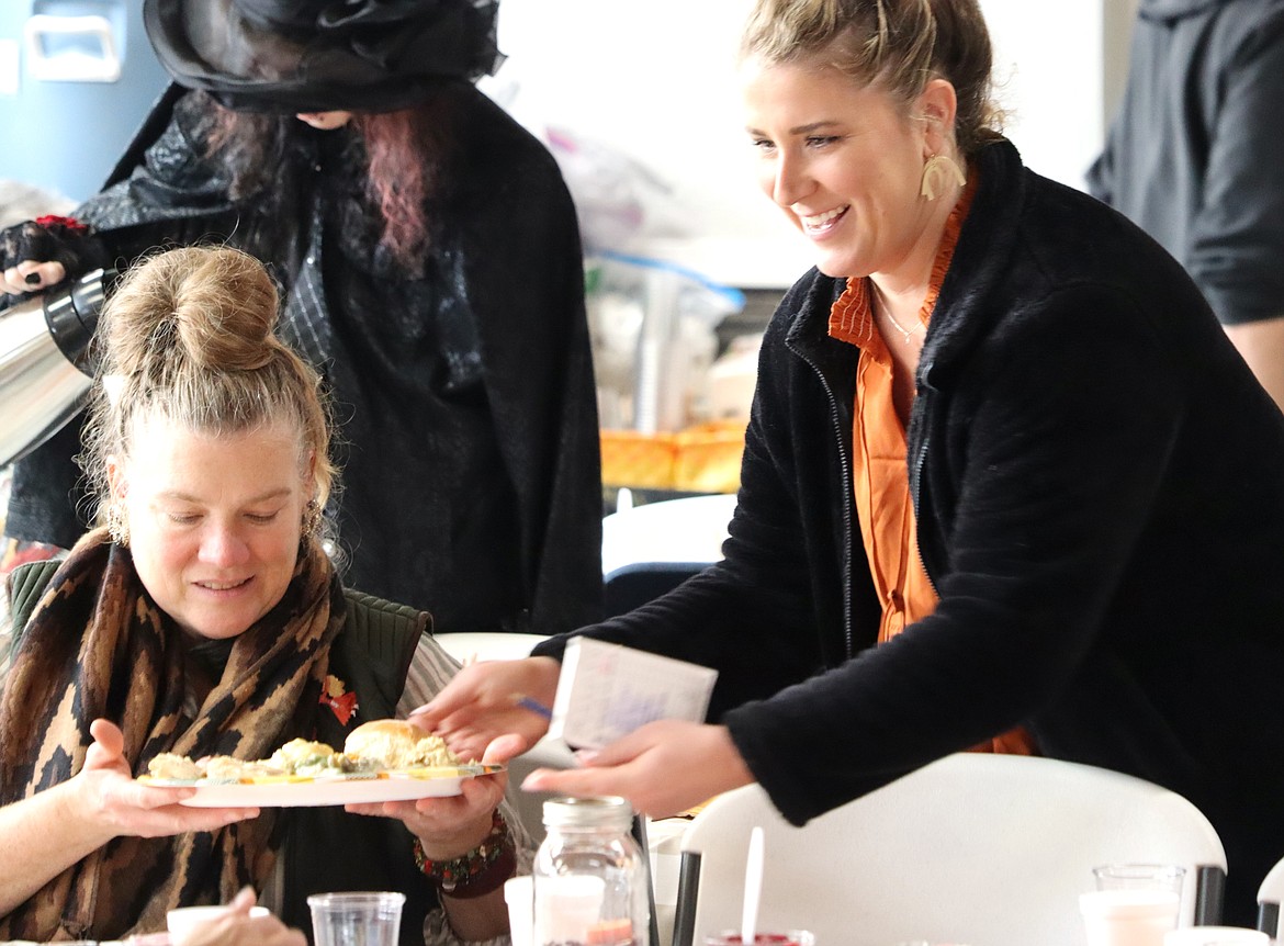 Volunteer Kamerin May smiles as she serves a Thanksgiving meal at The Altar Church.