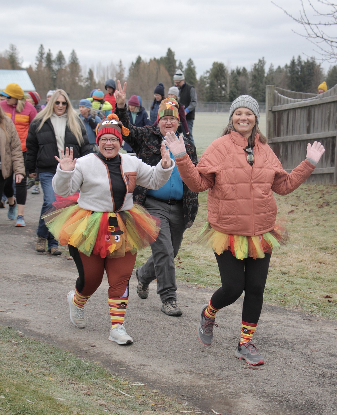 Turkey Trotters wave to the camera while taking part in the Thursday event.