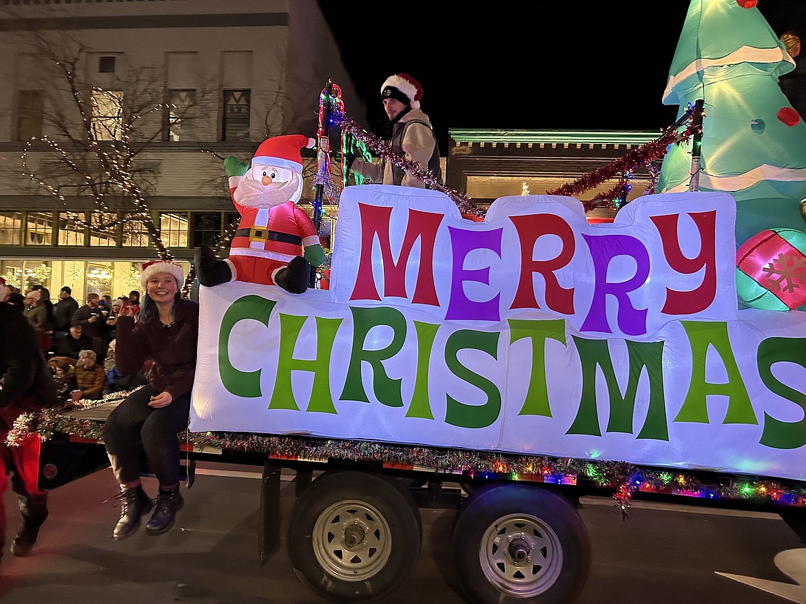 A parade entry wishes everyone a Merry Christmas.