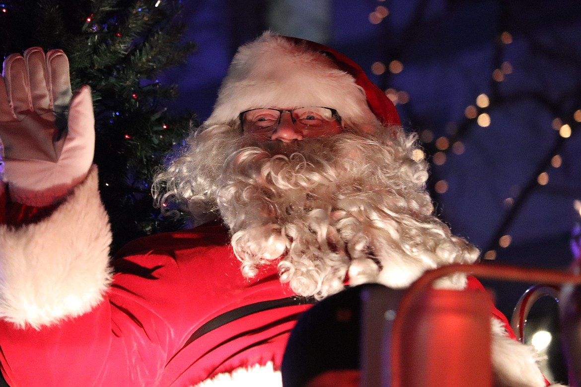 Santa Claus waves to the crowd as he highlights the parade on Friday.