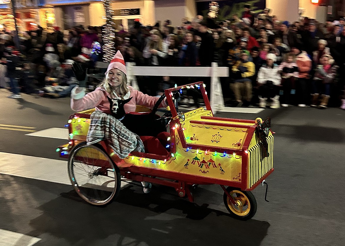 Ginger Harris drives through the Coeur d’Alene Downtown Association's Lighting Ceremony Parade on Friday on Sherman Avenue.