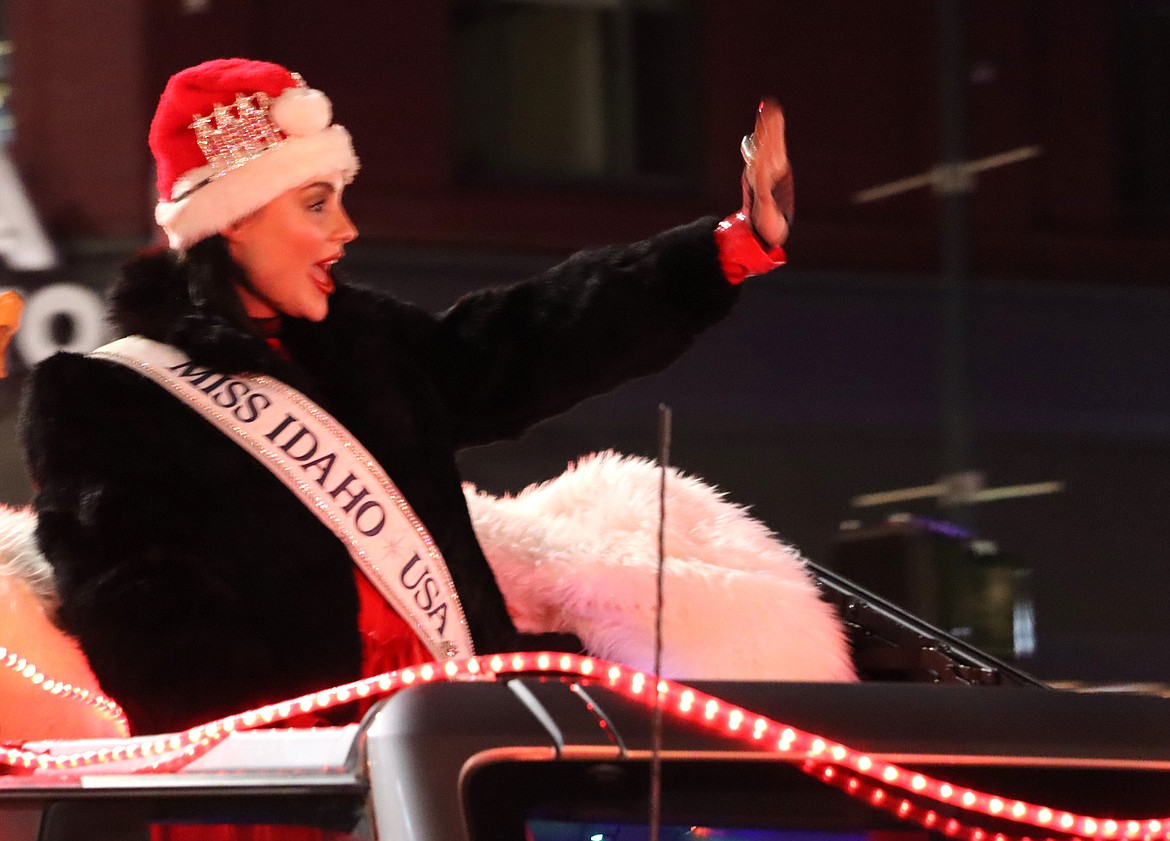 Miss Idaho USA, Kaitlyn Widmyer of Coeur d’Alene, and parade grand marshal, waves to the crowd.