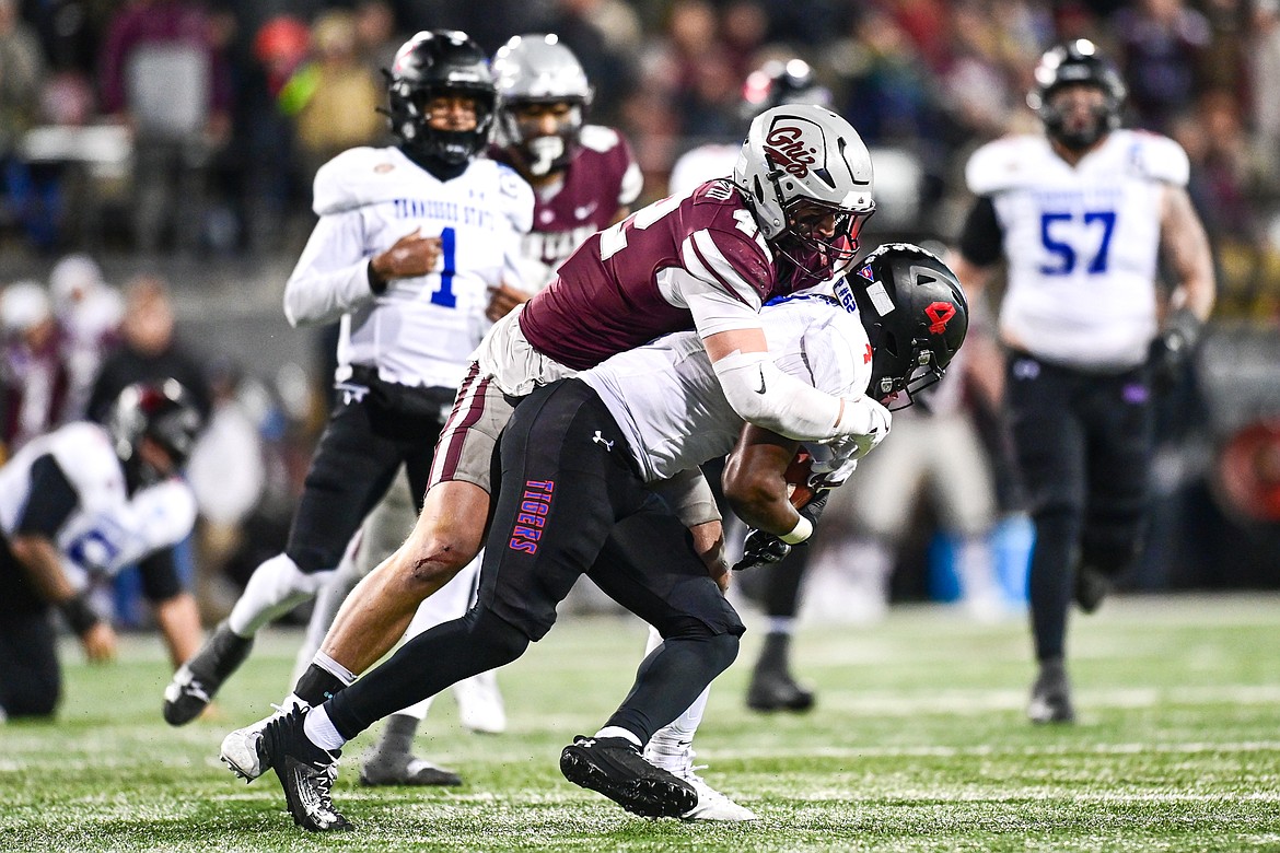 Grizzlies linebacker Riley Wilson (42) tackles Tennessee State running back Jaden McGill (4) in the third quarter in the opening round of the FCS Playoffs at Washington-Grizzly Stadium on Saturday, Nov. 30. (Casey Kreider/Daily Inter Lake)