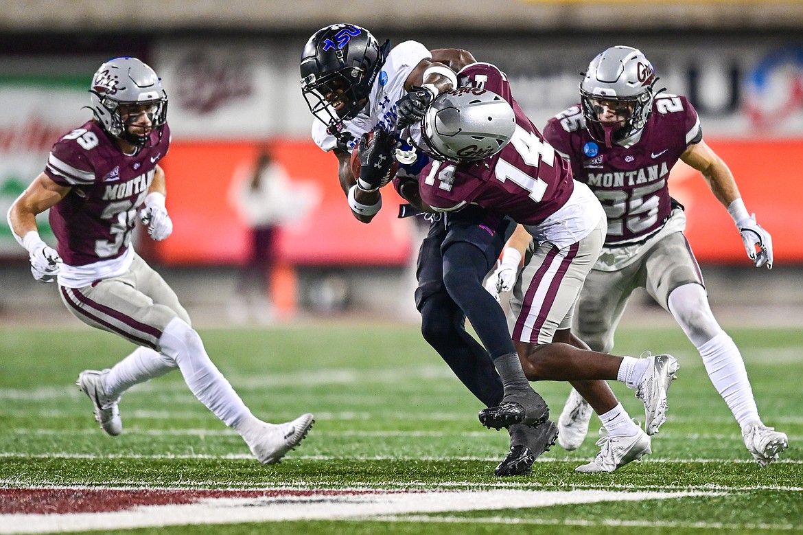 Grizzlies cornerback Kyon Loud (14) brings down Tennessee State wide receiver Jalal Dean (8) after a reception in the fourth quarter of the opening round of the FCS Playoffs at Washington-Grizzly Stadium on Saturday, Nov. 30. (Casey Kreider/Daily Inter Lake)