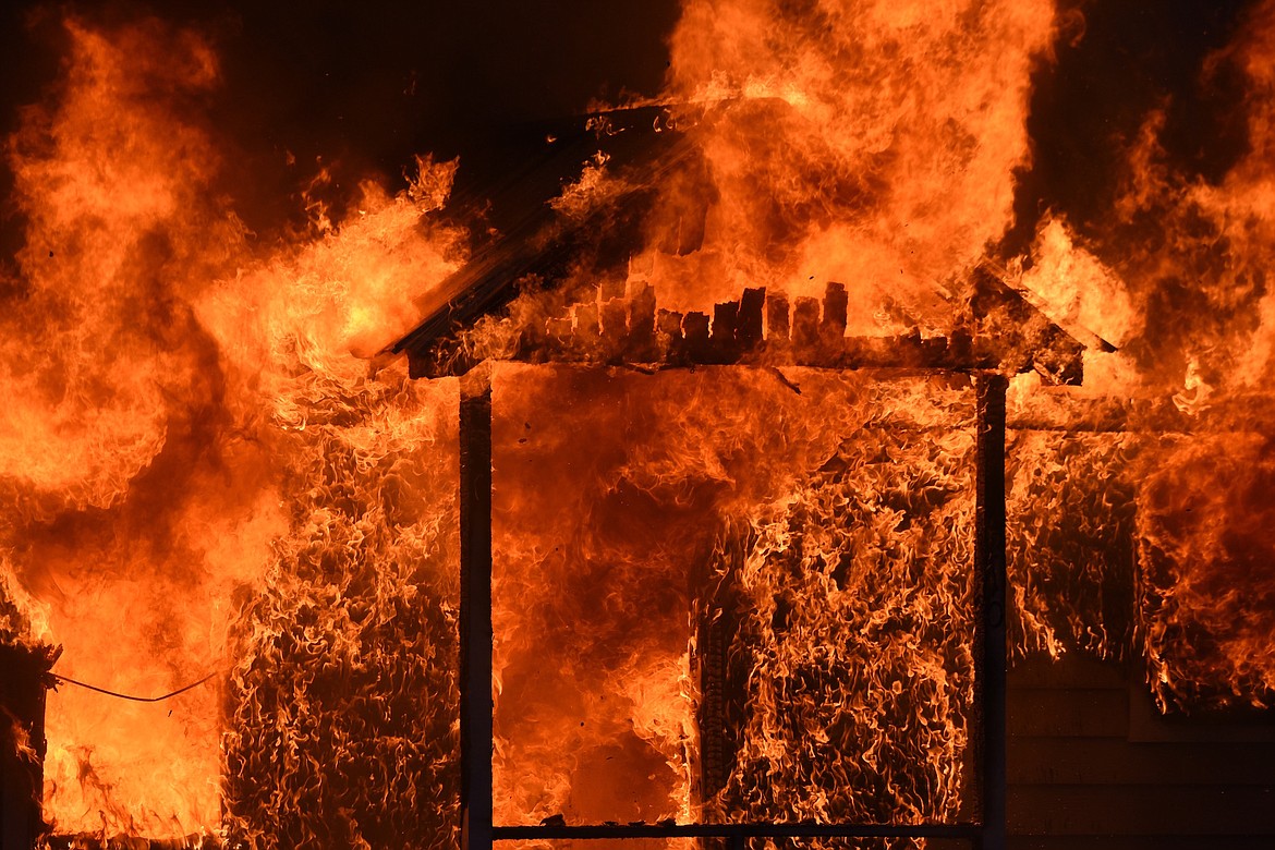 Flames burn a house at the corner of California Avenue and West Spruce Street in Libby Sunday, Dec. 1, 2024. (Scott Shindledecker/The Western News)