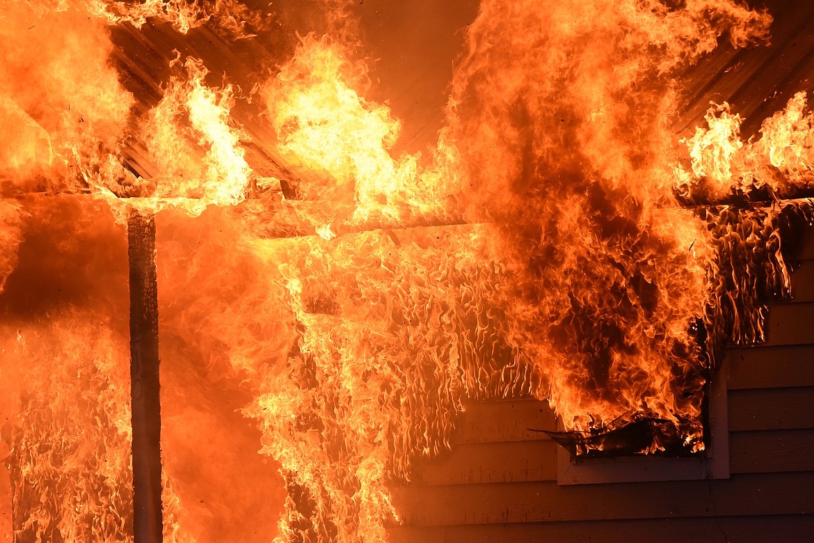 Flames burn a house at the corner of California Avenue and West Spruce Street in Libby Sunday, Dec. 1, 2024. (Scott Shindledecker/The Western News)