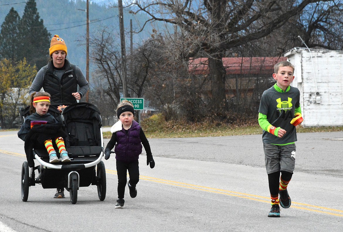 Mom and racer stopped along the route to let her daughter run for a stretch. (Mineral Independent/Amy Quinlivan)