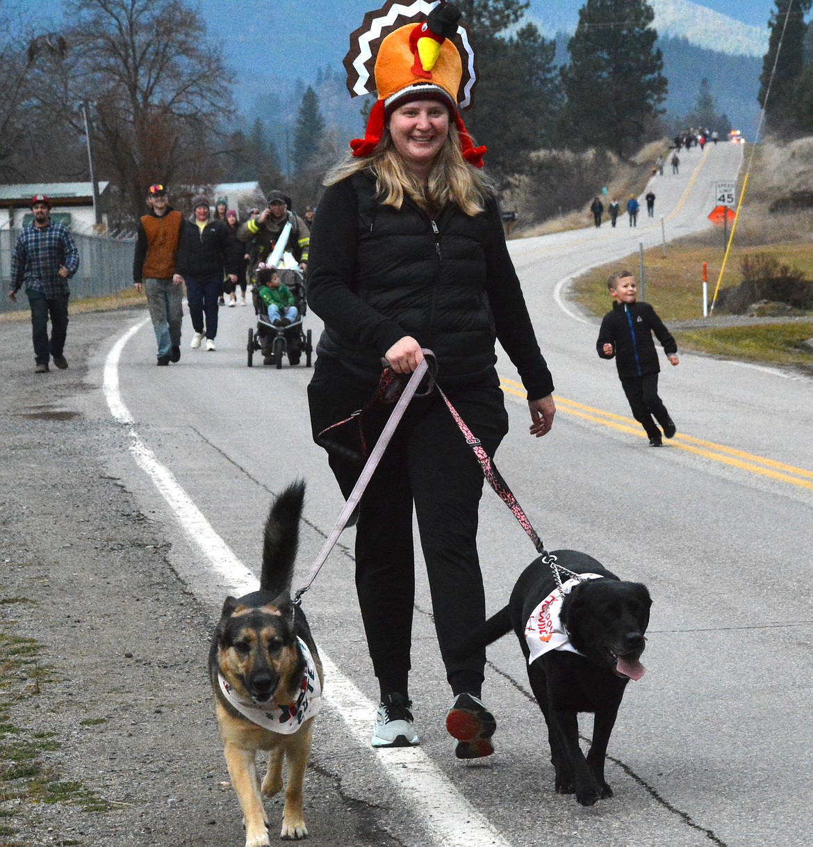 Bessie Spangler donned a festive gobbler on her head as she walked her two pups in the Turkey Trot. (Mineral Independent/Amy Quinlivan)