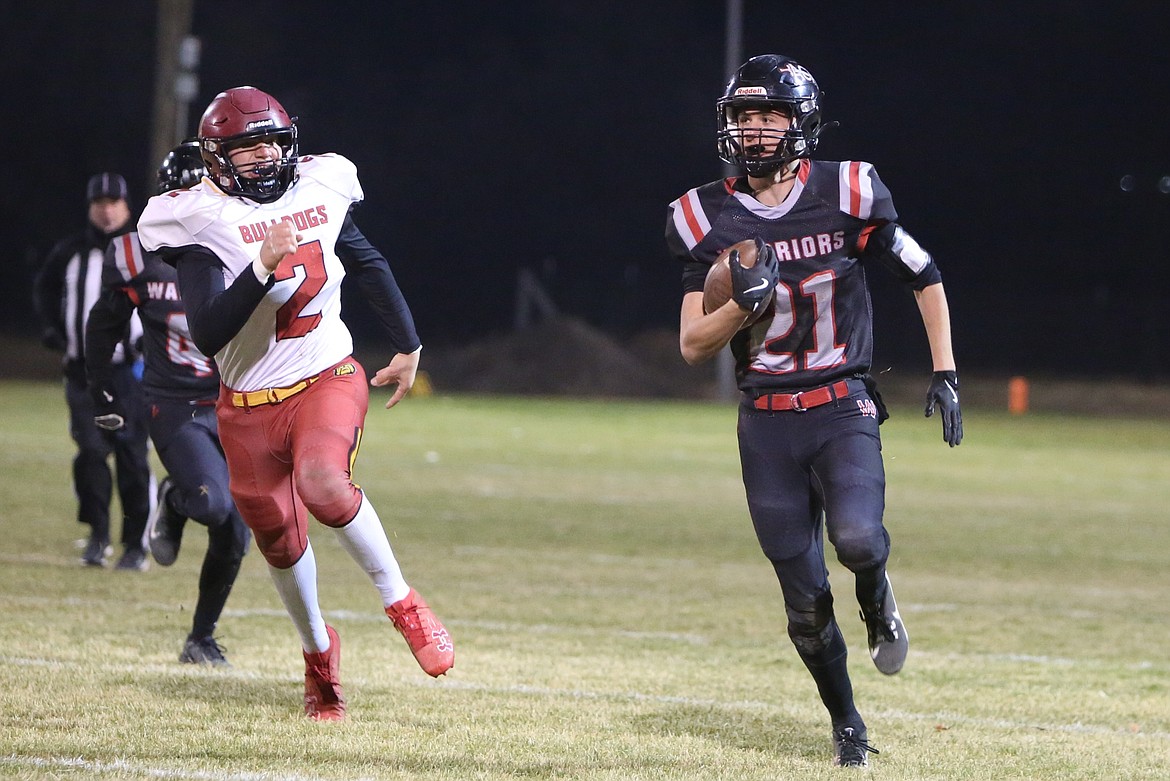 ACH junior Brady Roberts (21) carries the ball during a game against Dayton on Nov. 8. Roberts scored the first touchdown of the game against Liberty Christian on Saturday, reaching the end zone on an 18-yard rush.