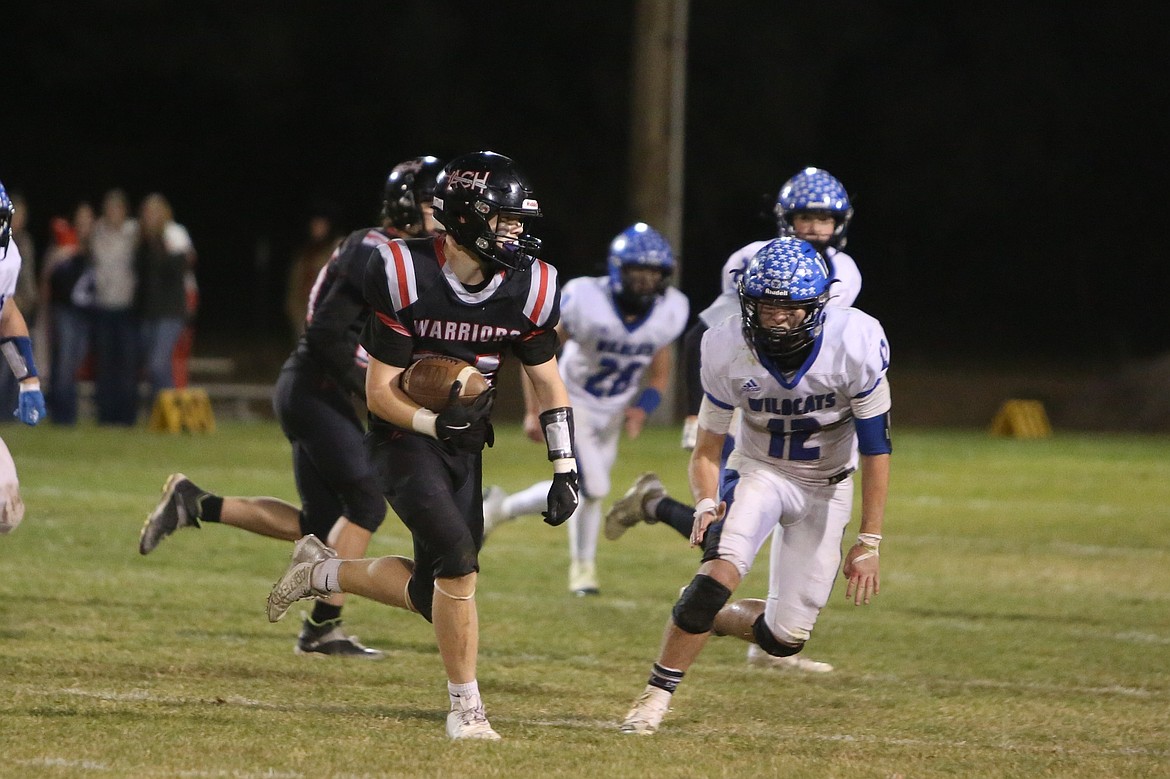 ACH senior Jameson Conley, left, runs with the football during a game against Wilbur-Creston-Keller on Oct. 25. Conley is one of eight seniors that will graduate off of this season’s roster.