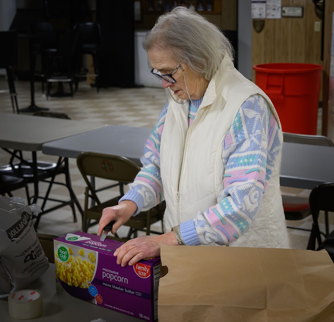 Volunteer Nora Verboorten prepares a care package. (Tracy Scott/Valley Press)