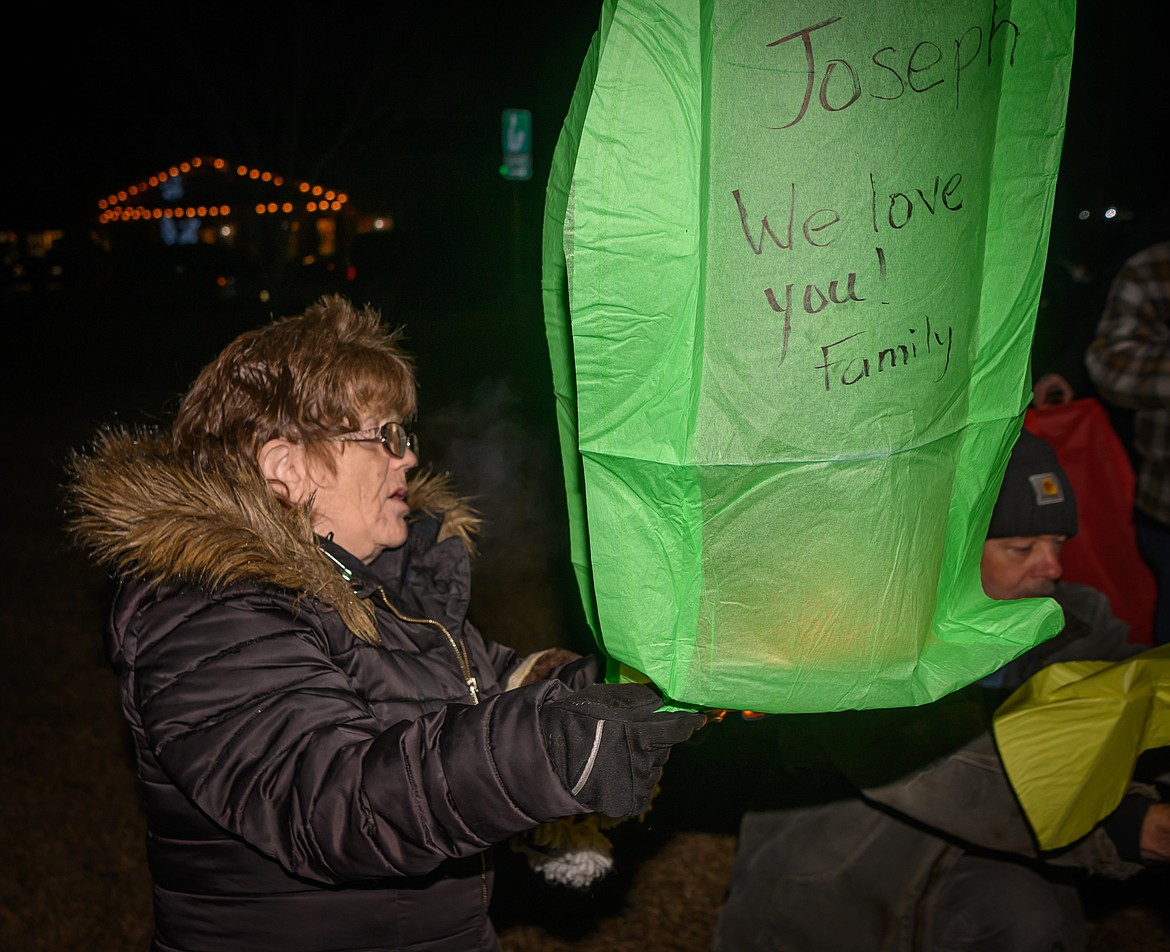 Adriene Galinat launches a lantern for a loved one during the Cancer Network fundraiser. (Tracy Scott/Valley Press)