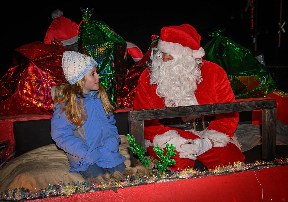 Adeline Huyghe, 7, from Plains has a discussion with Santa during the tree lighting and parade celebrations. (Tracy Scott/Valley Press)