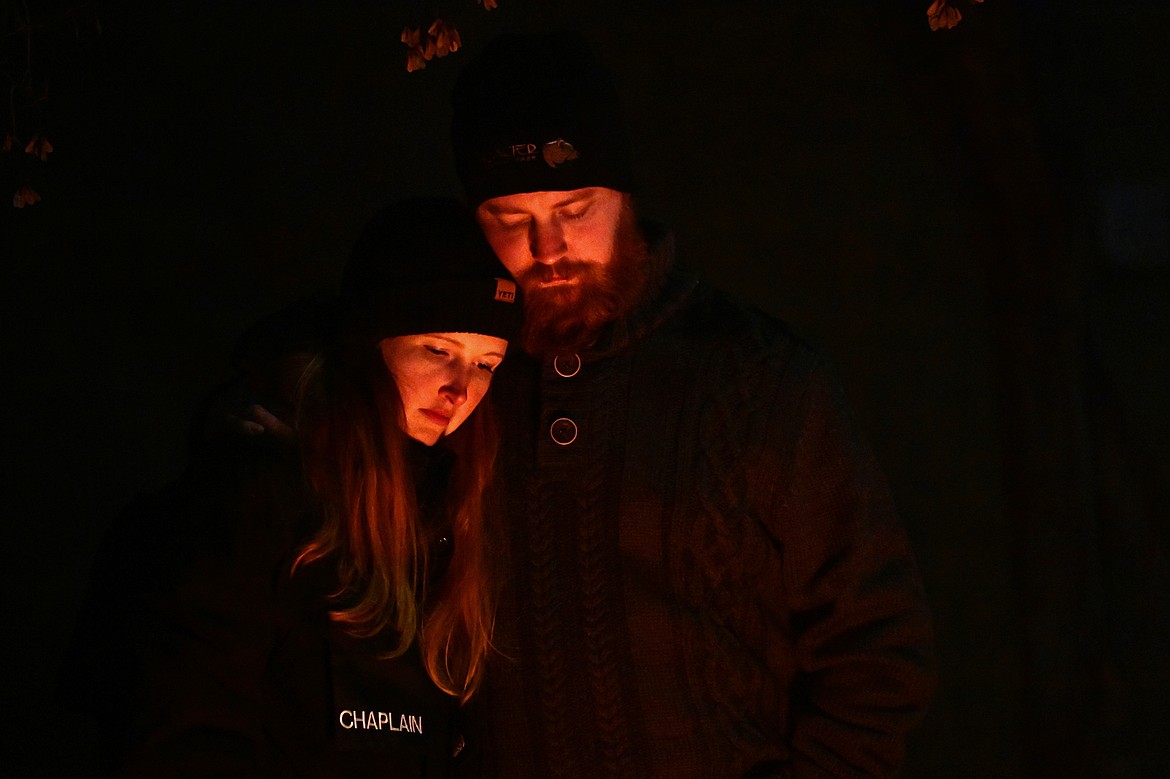 Attendees bow their heads for a moment of prayer at the Blue Light Christmas Tree Lighting ceremony outside the Flathead County Justice Center in Kalispell on Tuesday, Dec. 3. The event is held in support of the families of fallen officers and to honor the officers, firefighters, first responders and all those who serve and protect. (Casey Kreider/Daily Inter Lake)