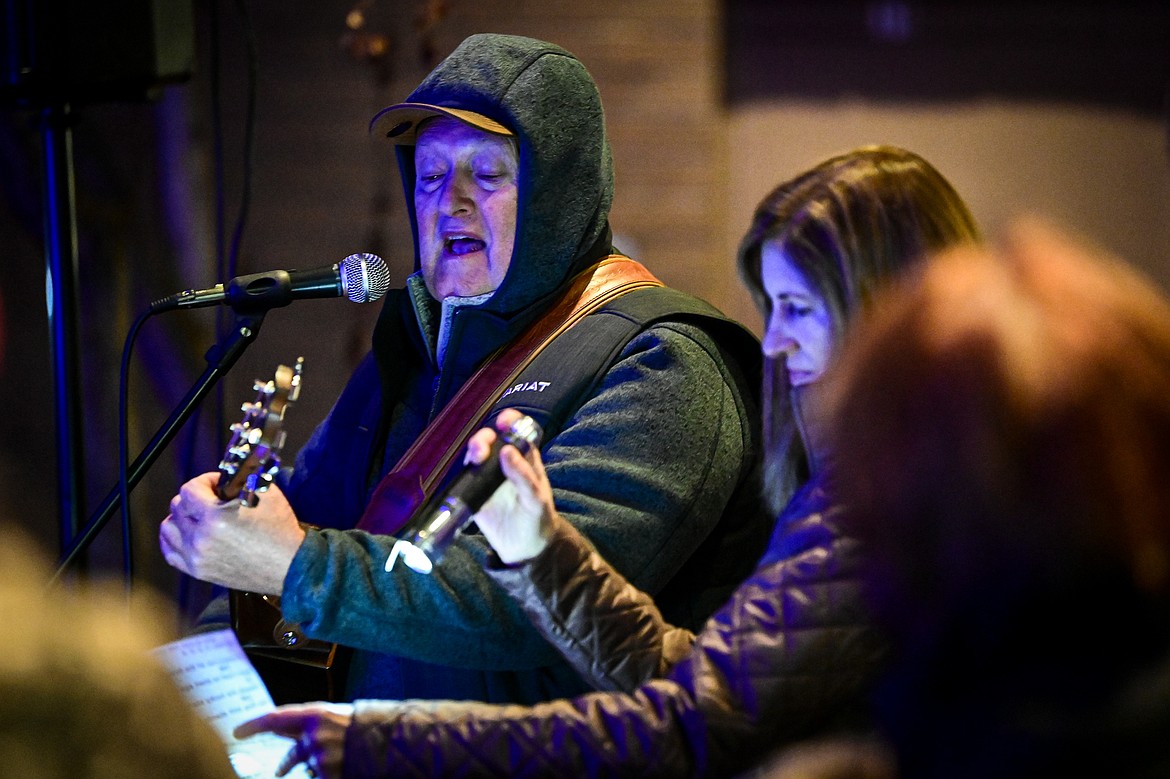 Musician Randy Marshall sings "Silent Night" with attendees at the Blue Light Christmas Tree Lighting ceremony outside the Flathead County Justice Center in Kalispell on Tuesday, Dec. 3. The event is held in support of the families of fallen officers and to honor the officers, firefighters, first responders and all those who serve and protect. (Casey Kreider/Daily Inter Lake)