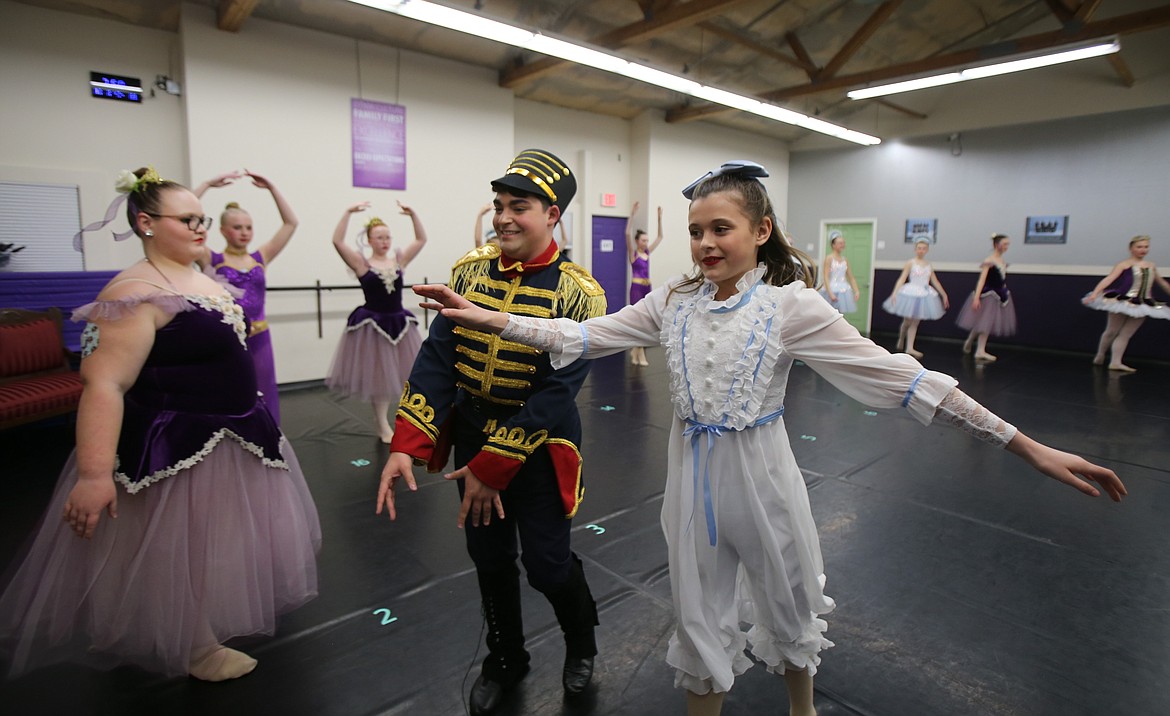 Brandon Holder as the Nutcracker and Rilee Jurcevich prance off stage during Dec. 2's rehearsal of "The Nutcracker."