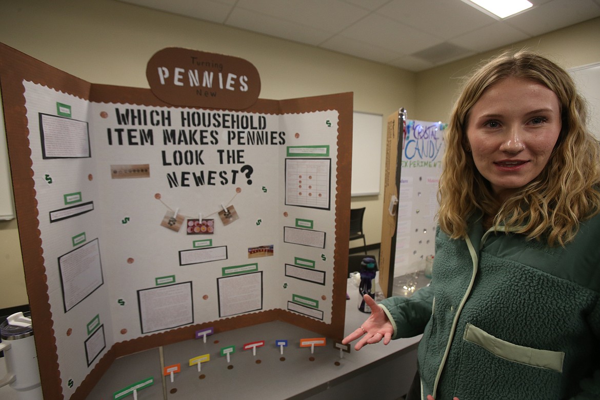 Emma McIntire, an elementary education student at the University of Idaho — Coeur d'Alene, discusses her penny-cleaning science project Dec. 3 during a class science fair on the North Idaho College campus.