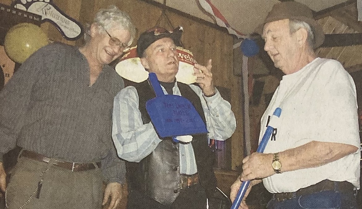 In 1999, outgoing mayor George (Swamp) Watters, left, passes the gavel to his successor, Tom Dahmen, right, while master of ceremonies Dick Wandrocke watches.