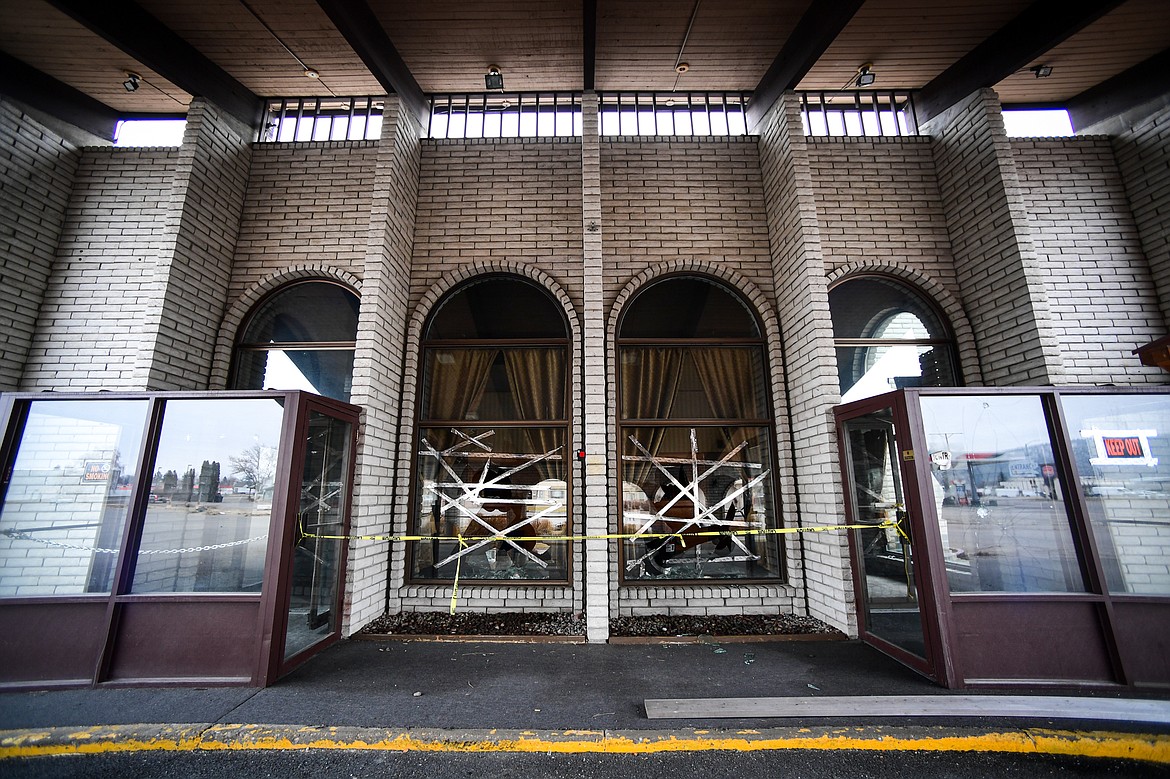 Tape is placed across broken windows at an entrance to the former Fairbridge Inn & Suites and Outlaw Convention Center in Kalispell on Wednesday, Dec. 4. (Casey Kreider/Daily Inter Lake)