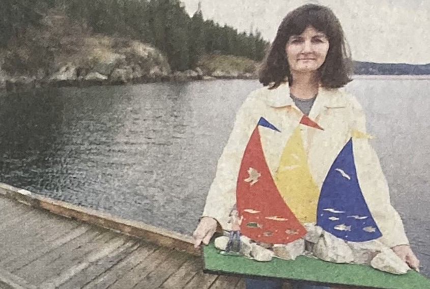 In 2009, Donna Bain poses with her public art piece, “Catch the Wind.”