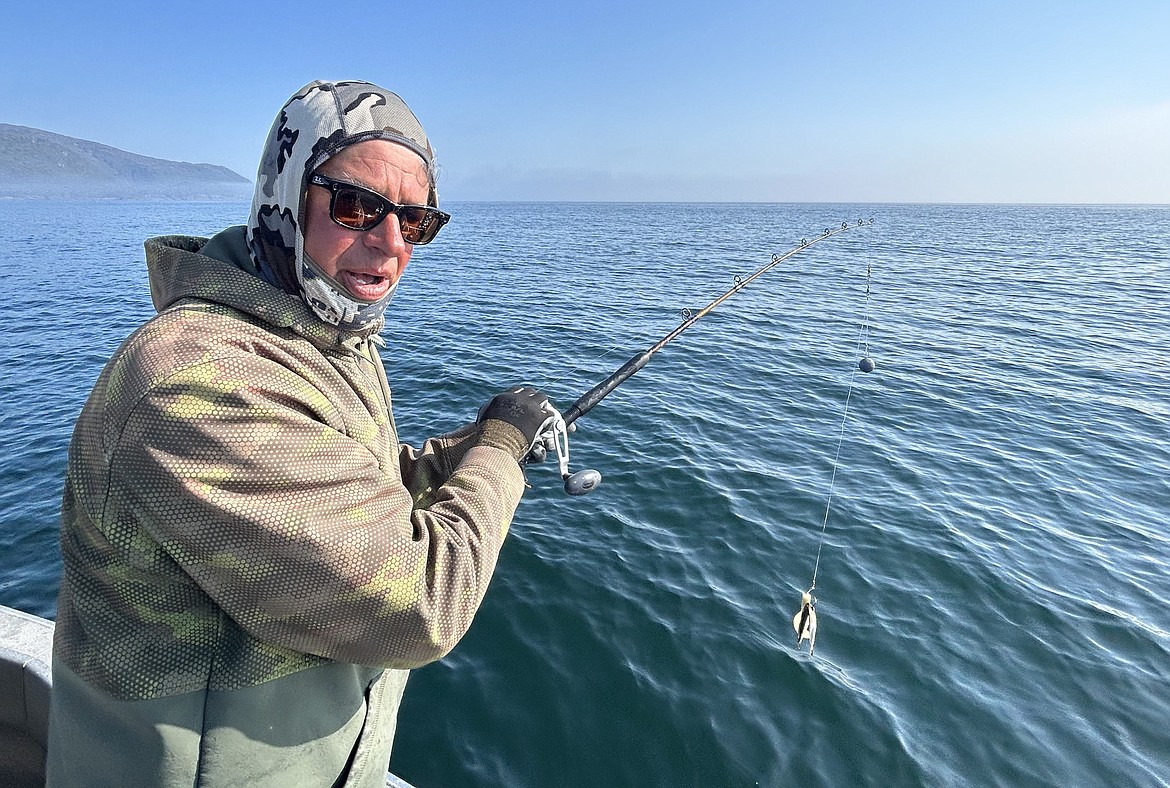 Mike Bunker of Coeur d'Alene readies to reel in a salmon during a fishing trip in Ketchikan in August.