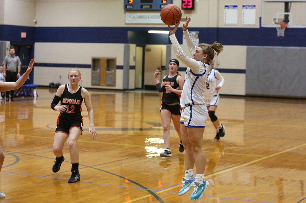 Soap Lake junior Liana Sushik, in white, attempts a three-pointer during the first half of Tuesday’s game against Republic.