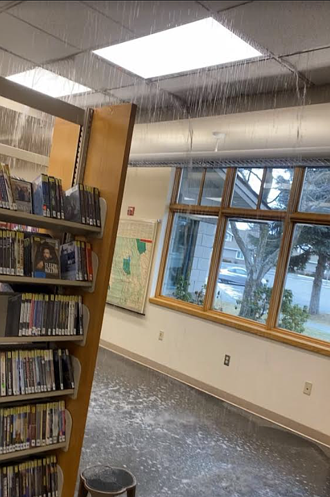 Water pours from the ceiling of the Post Falls Library in January after freezing weather ruptured the pipes and sprinkler system. Post Falls and Athol libraries, which have been closed for months due to weather damage.