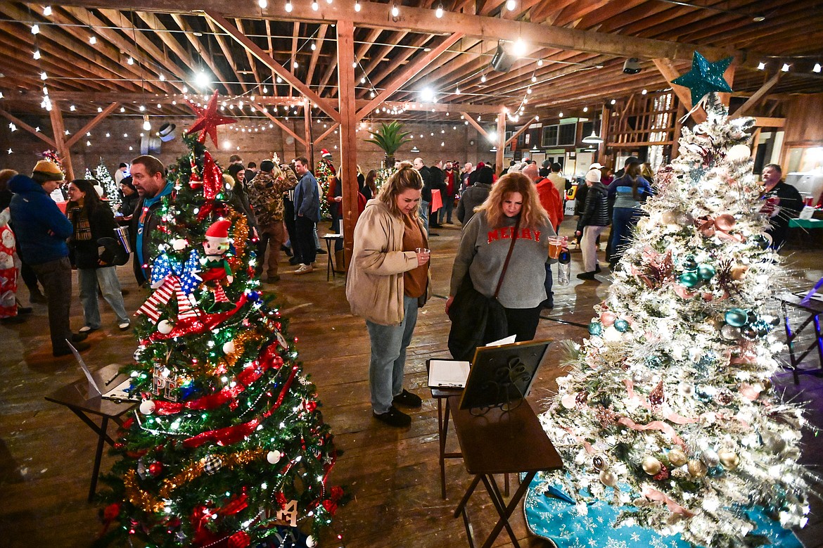 Visitors check out decorated trees inside the KM Building at the Downtown Holiday Stroll & Tree Lighting Ceremony on Friday, Dec. 6. (Casey Kreider/Daily Inter Lake)