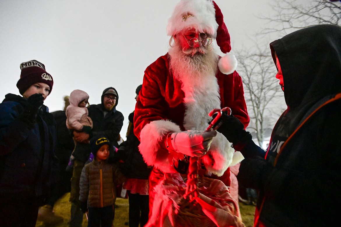 Santa Claus hands out candy canes before the tree lighting at the Downtown Holiday Stroll & Tree Lighting Ceremony on Friday, Dec. 6. (Casey Kreider/Daily Inter Lake)