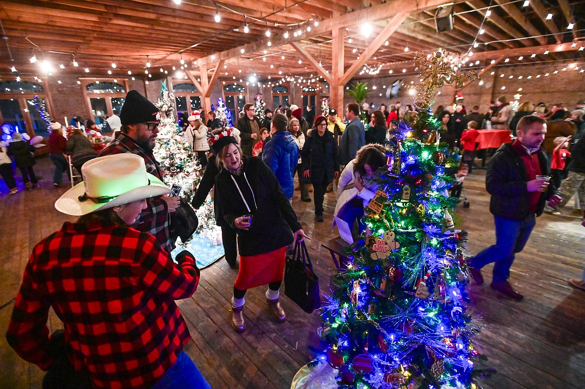 Visitors check out decorated trees inside the KM Building at the Downtown Holiday Stroll & Tree Lighting Ceremony on Friday, Dec. 6. (Casey Kreider/Daily Inter Lake)