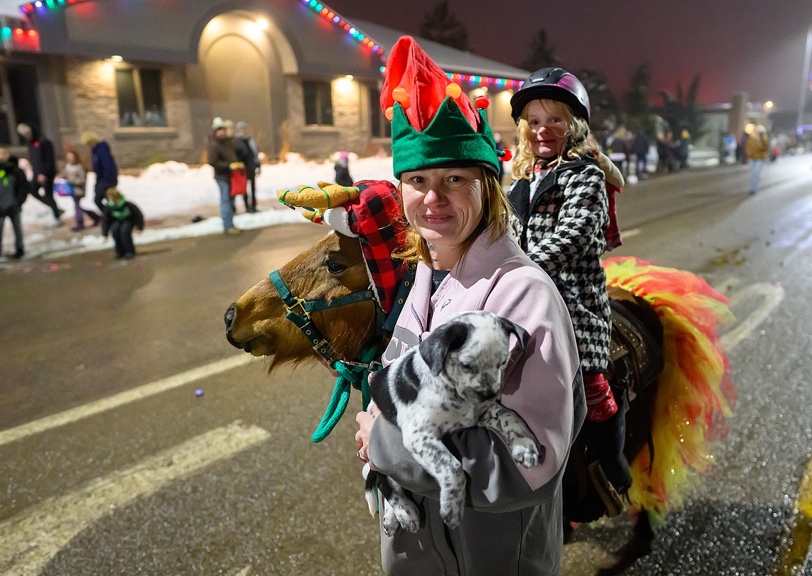 A reveler has her hands full while walking in the parade.