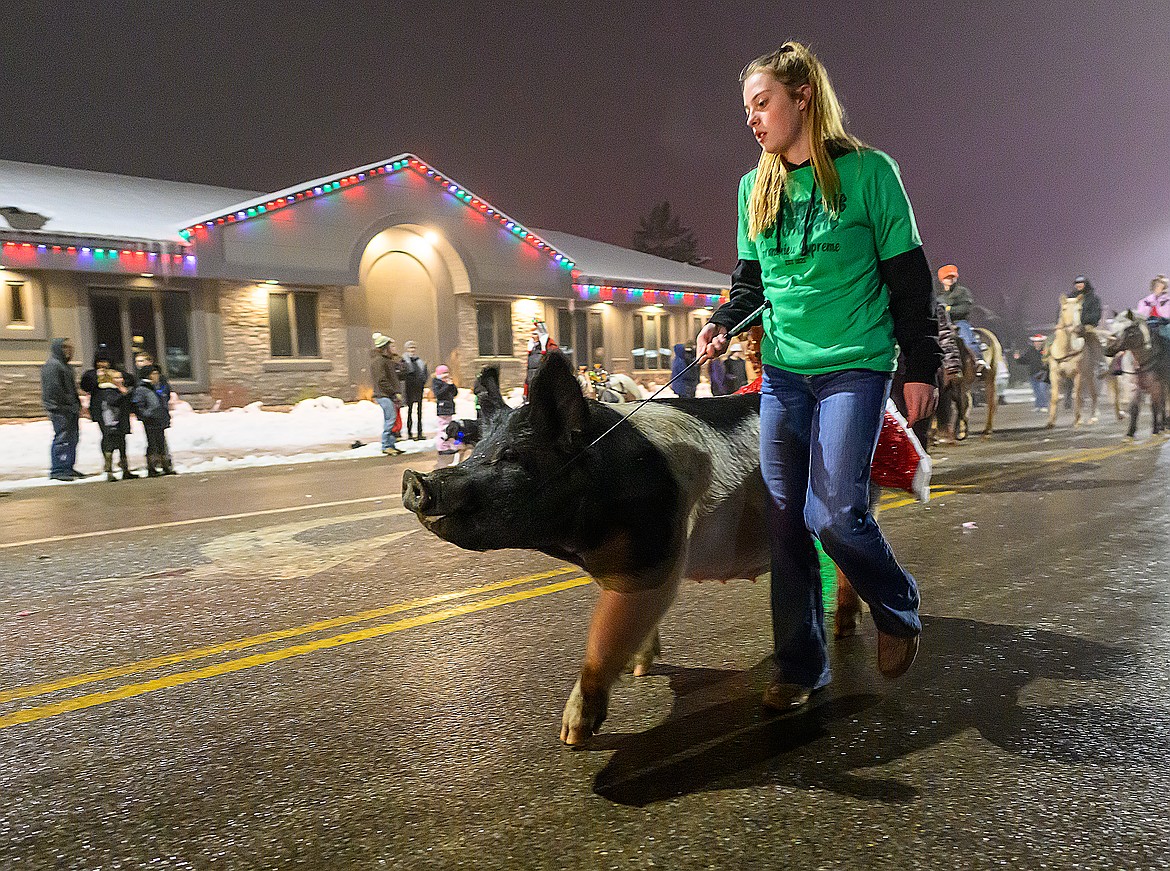 Teagan Flint guides her pig through the parade.