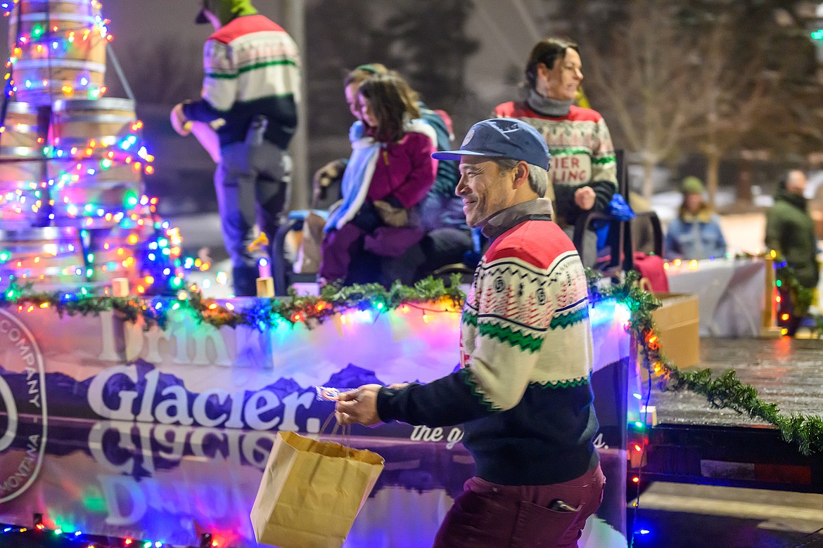 Nic Lee hands out candy from the Glacier  Distillery float.