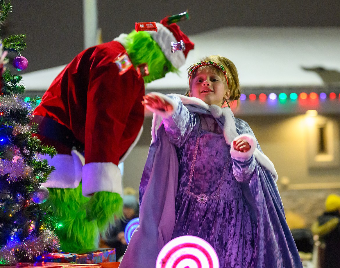 Cindy-Lou Hoo throws candy to the crowd.