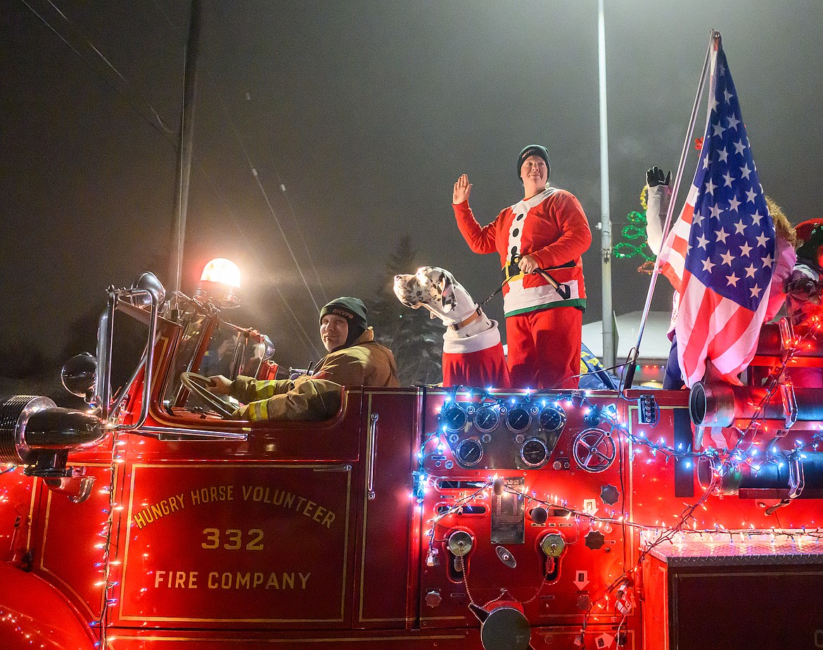 The Hungry Horse Volunteer Fire Department rolls its vintage engine through the parade.