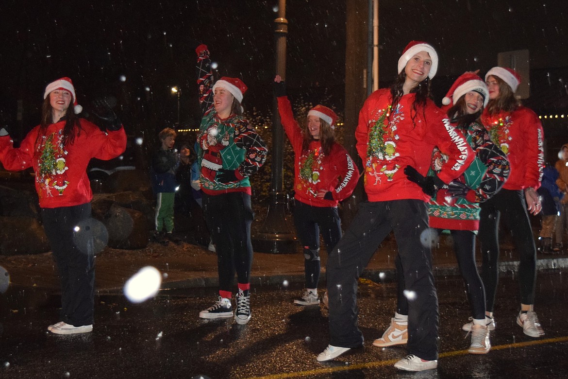 Local dancers grin their way through rain and snow during the Hayden Lights Parade on Saturday night.