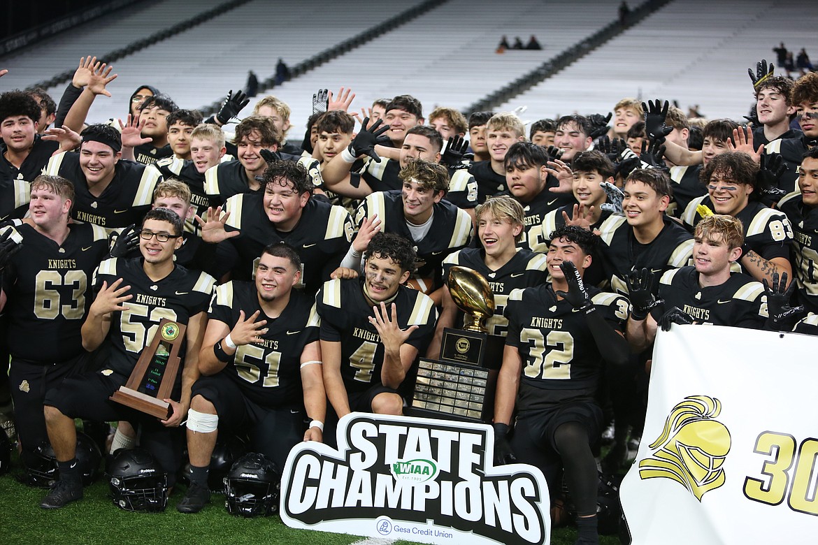 Royal players celebrate after defeating Seton Catholic 61-28 in Friday’s 1A championship game at Husky Stadium in Seattle. Players held up five fingers – one for each of Royal’s five consecutive championship wins.