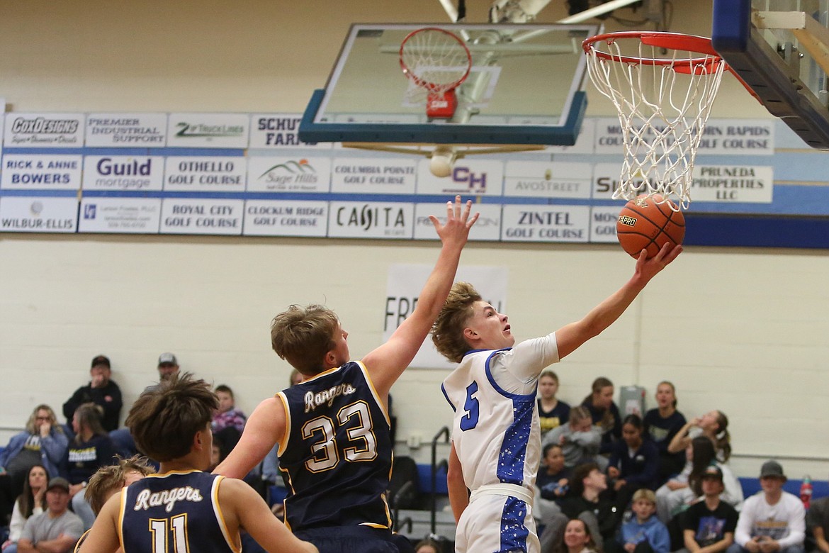 Warden junior Eli Cox (5) drives toward the basket in the first half against Naches Valley on Thursday. Cox scored 14 points in the game.