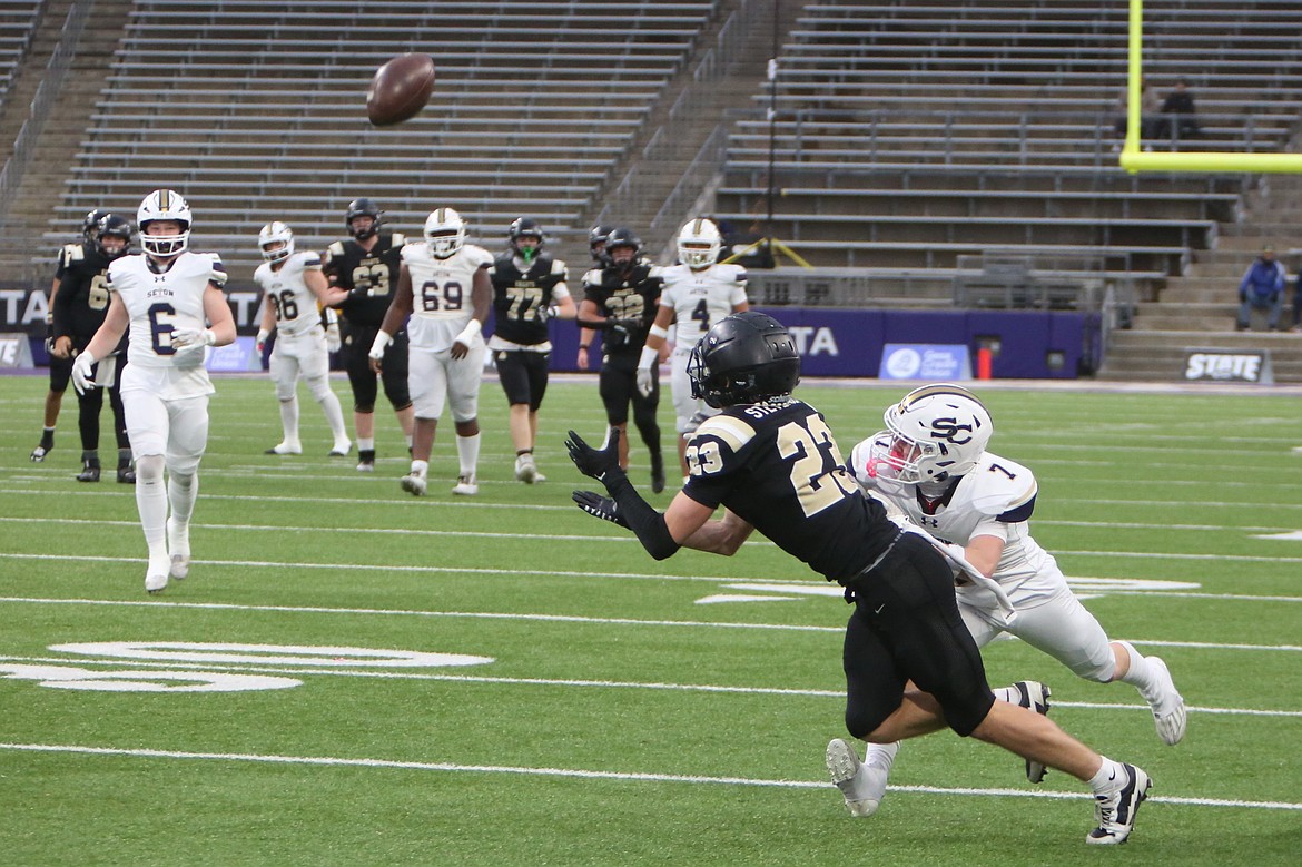 Royal junior Shea Stevenson (23) dives to secure a catch in the first half against Seton Catholic on Friday. Stevenson led the Knights with six catches for 89 yards.