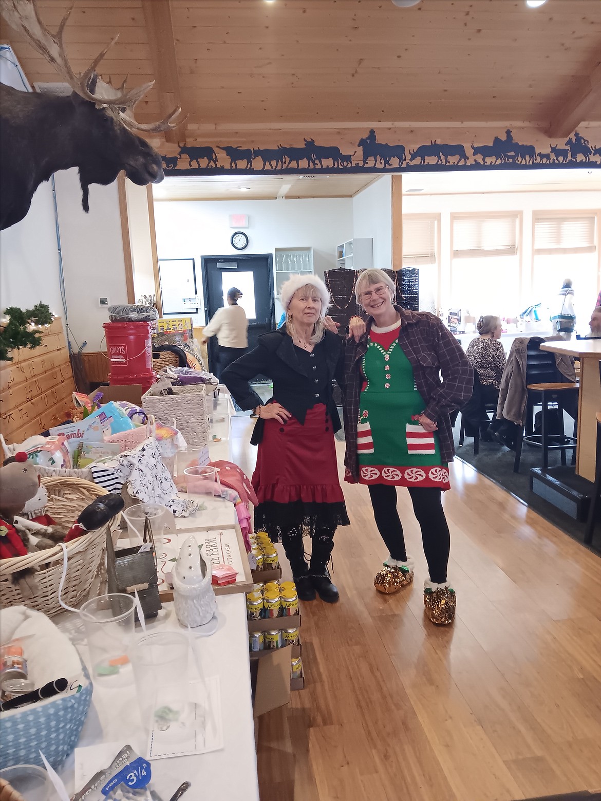 Kristi Thisselle and Donna Perkins were the auctioneers’ aides during the Helping Hands Auction in Alberton. The auction has been taking place for about 30 years helping families at Christmas time. There are several people that are on the board of directors or volunteers with Helping Hands that were recipients of this auction when they were children. (Monte Turner/Mineral Independent)