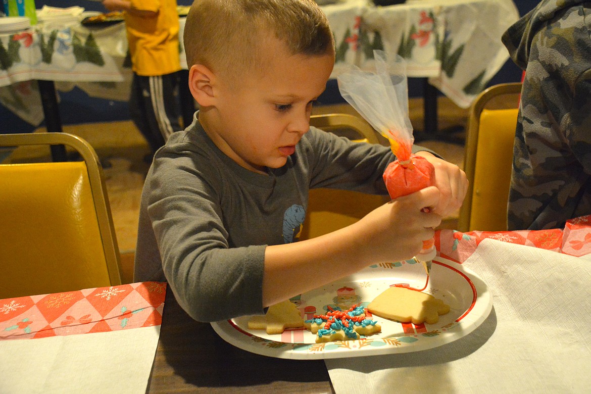 For little hands using piping bags for the colorful frosting was hard work, but it was tasty work.  (Amy Quinlivan)