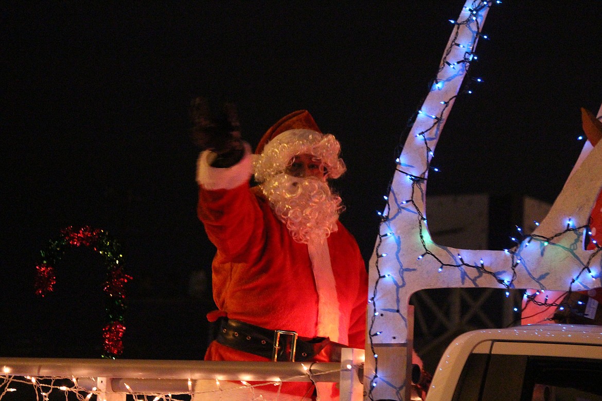 Santa waves from the back of a float during the annual Ag Parade in Moses Lake.