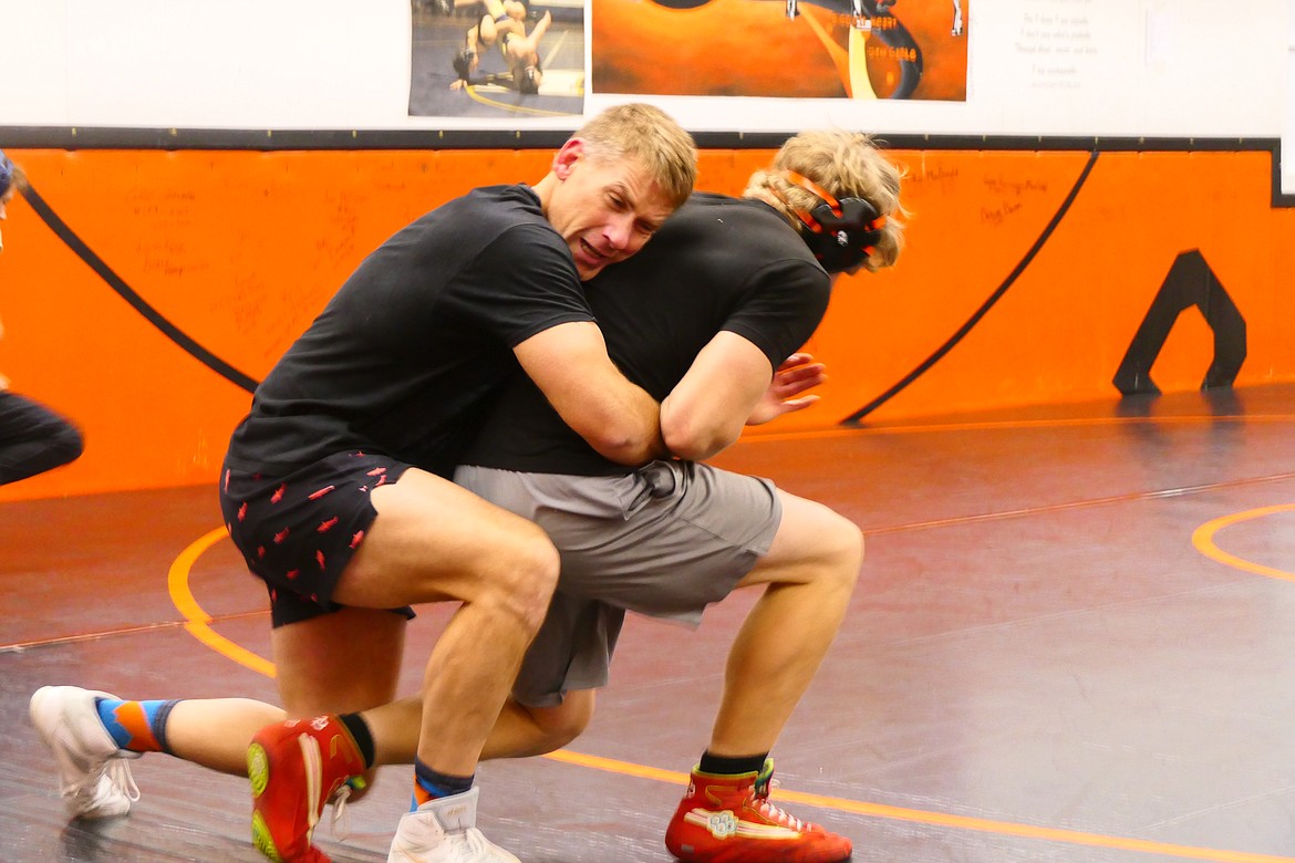 Hot Springs track coach and assistant football coach (left) works with Hot Springs student David Chapman during preseason practice for the Plains-Hot Springs wrestling team this week in Plains.  (Chuck Bandel/VP-MI)